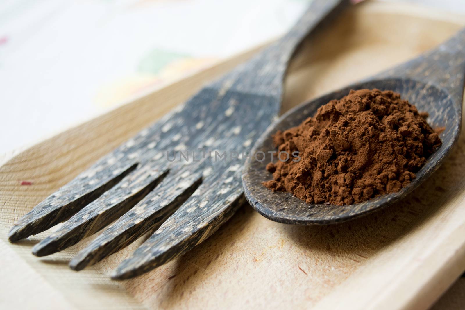 coffee grounds on a wooden spoon near a wooden fork