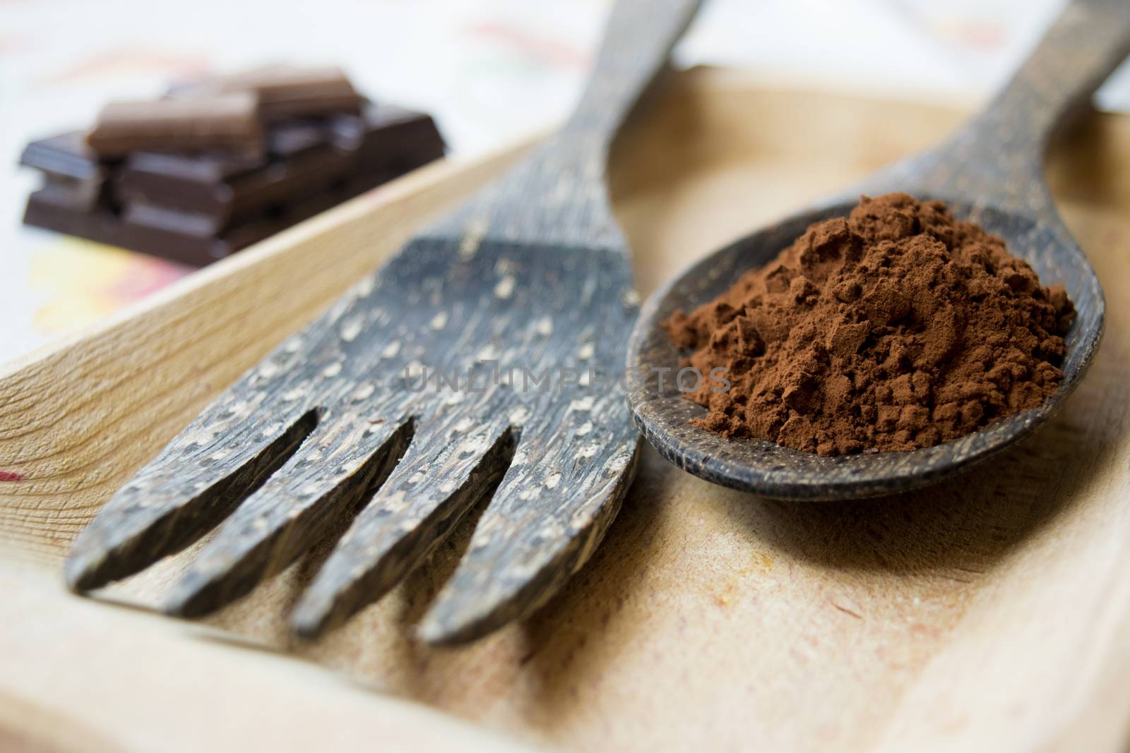 coffee grounds on a wooden spoon near a wooden fork