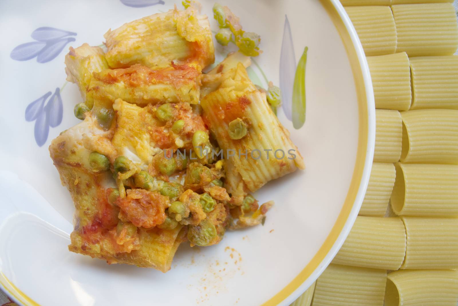 dish of baked pasta near grains of paccheri 