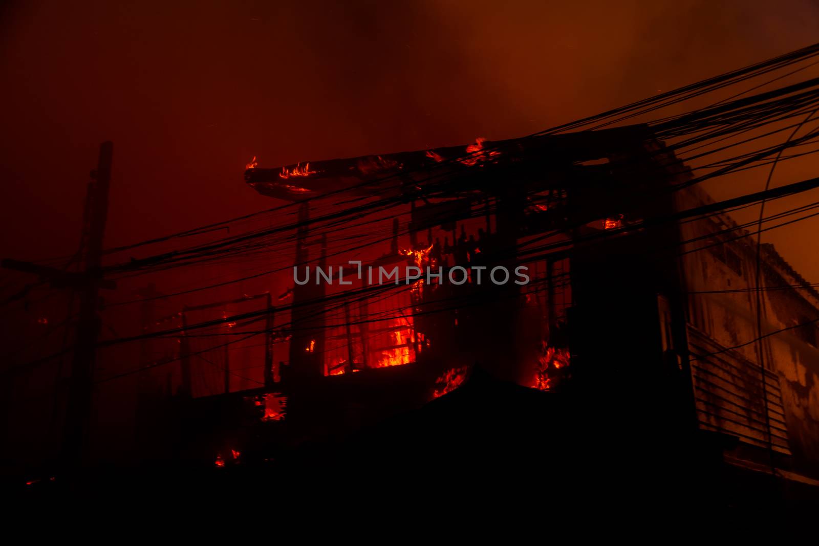 The silhouette of Burning house by Naypong