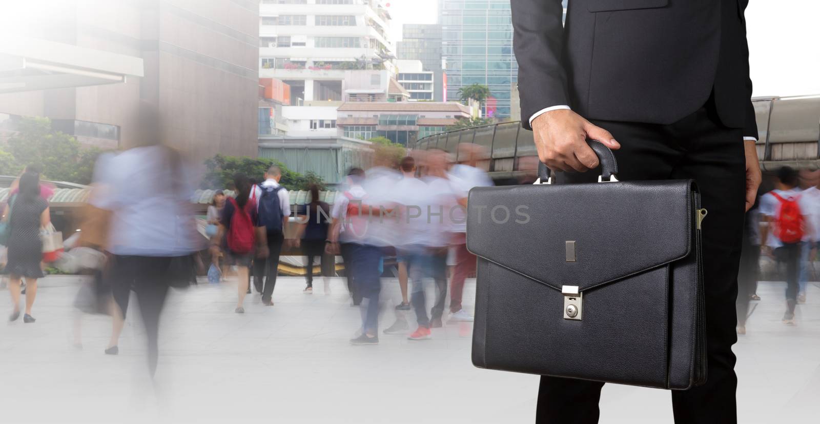 Businessman holding a briefcase by Naypong