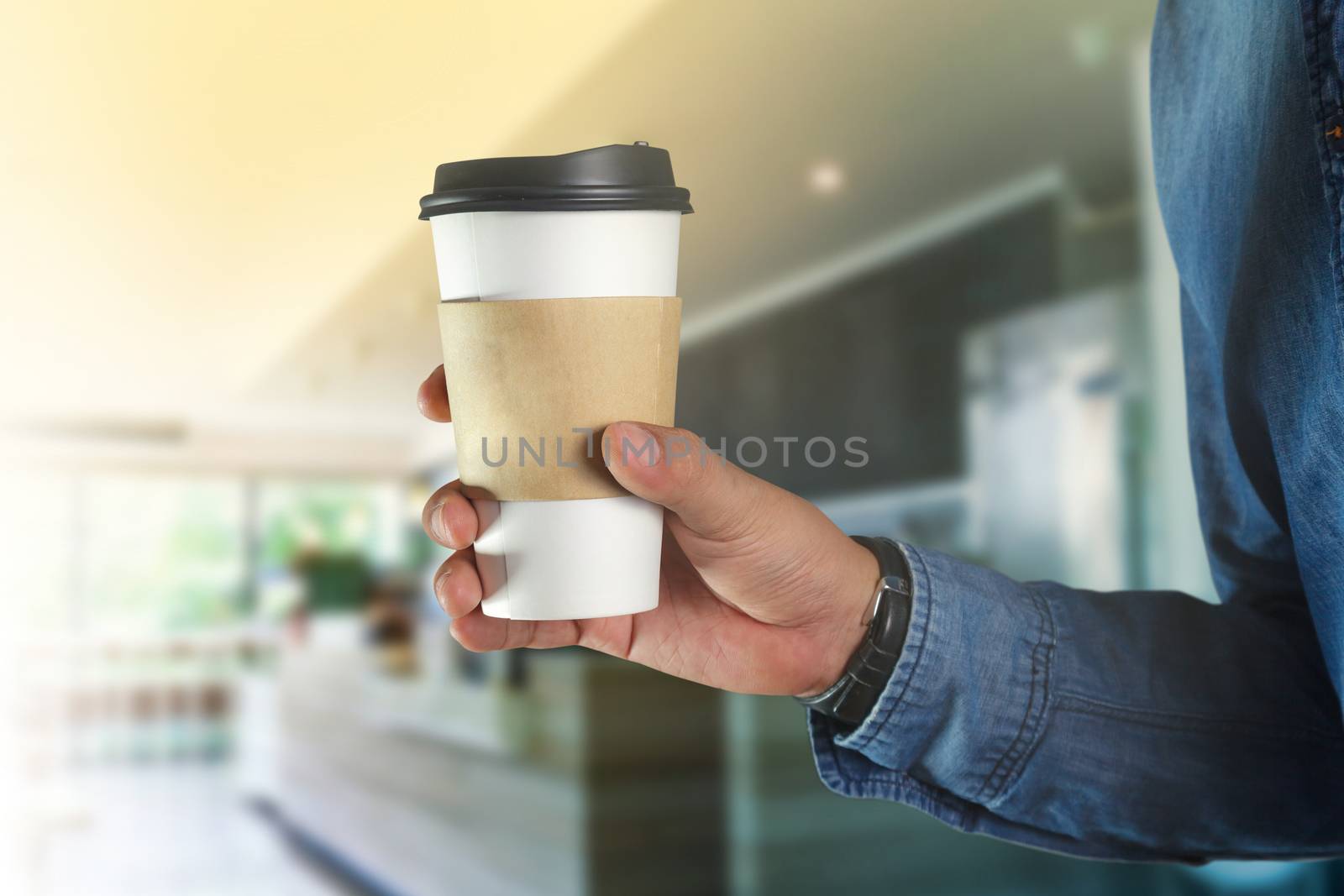 A young man holding a coffee  by Naypong