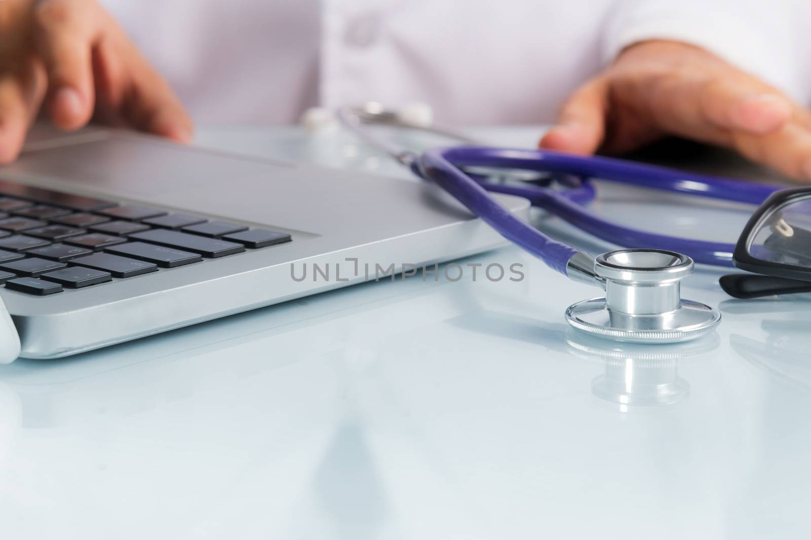 Healthcare And Medicine, Doctor with stethoscope and Laptop on desk