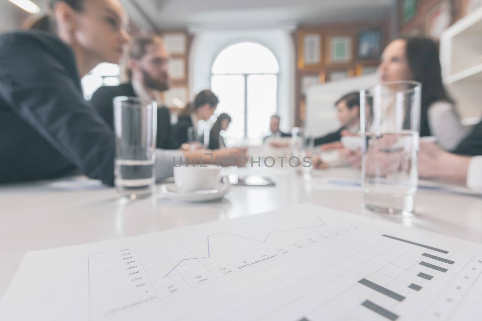 Business people at meeting in office discuss financial charts