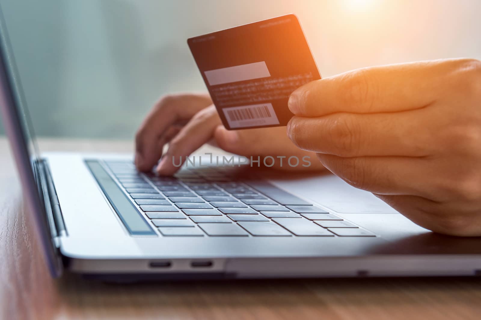 Online shopping concept. Hands holding credit card and using laptop computer.