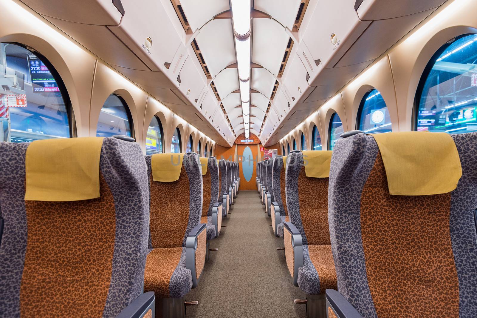 Interior of a train with empty seats. Modern train seats.