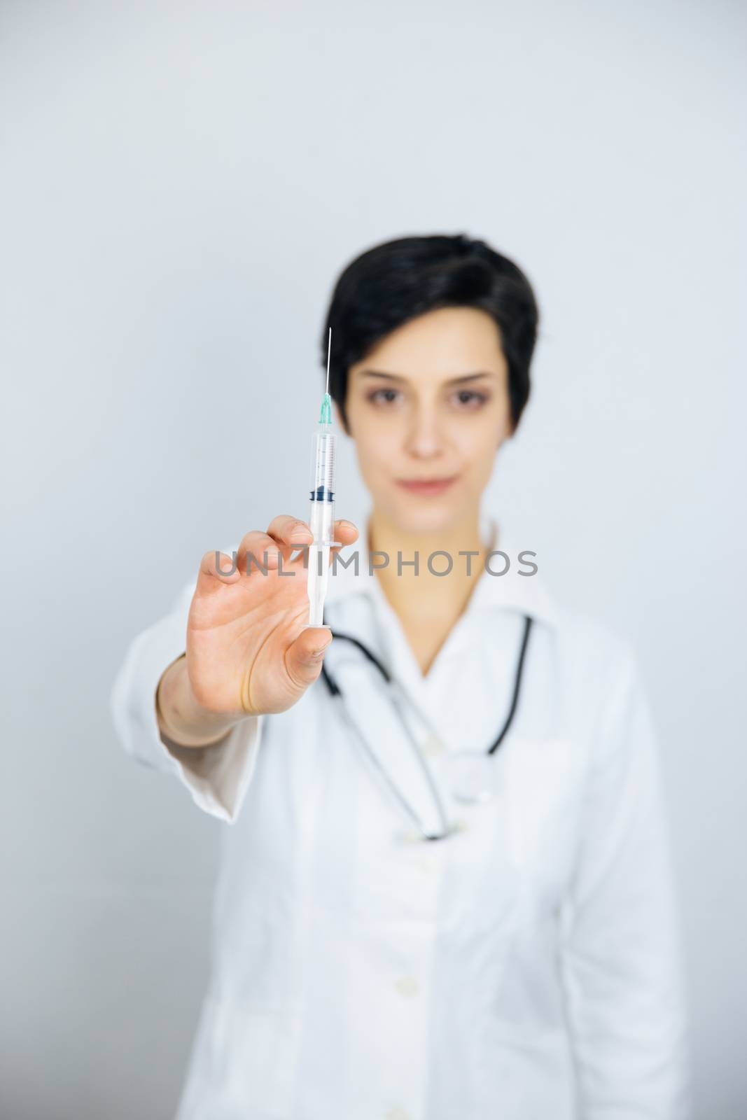 Female doctor with syringe, isolated on white background. Medicine and health care concept.