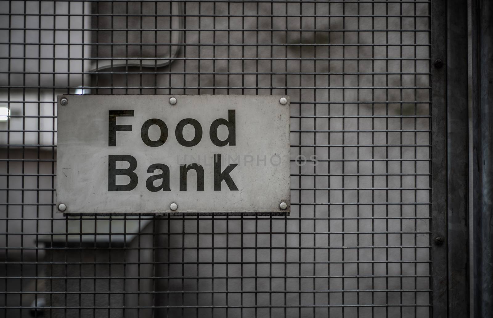 A Grungy Sign For A Food Bank In A Backstreet
