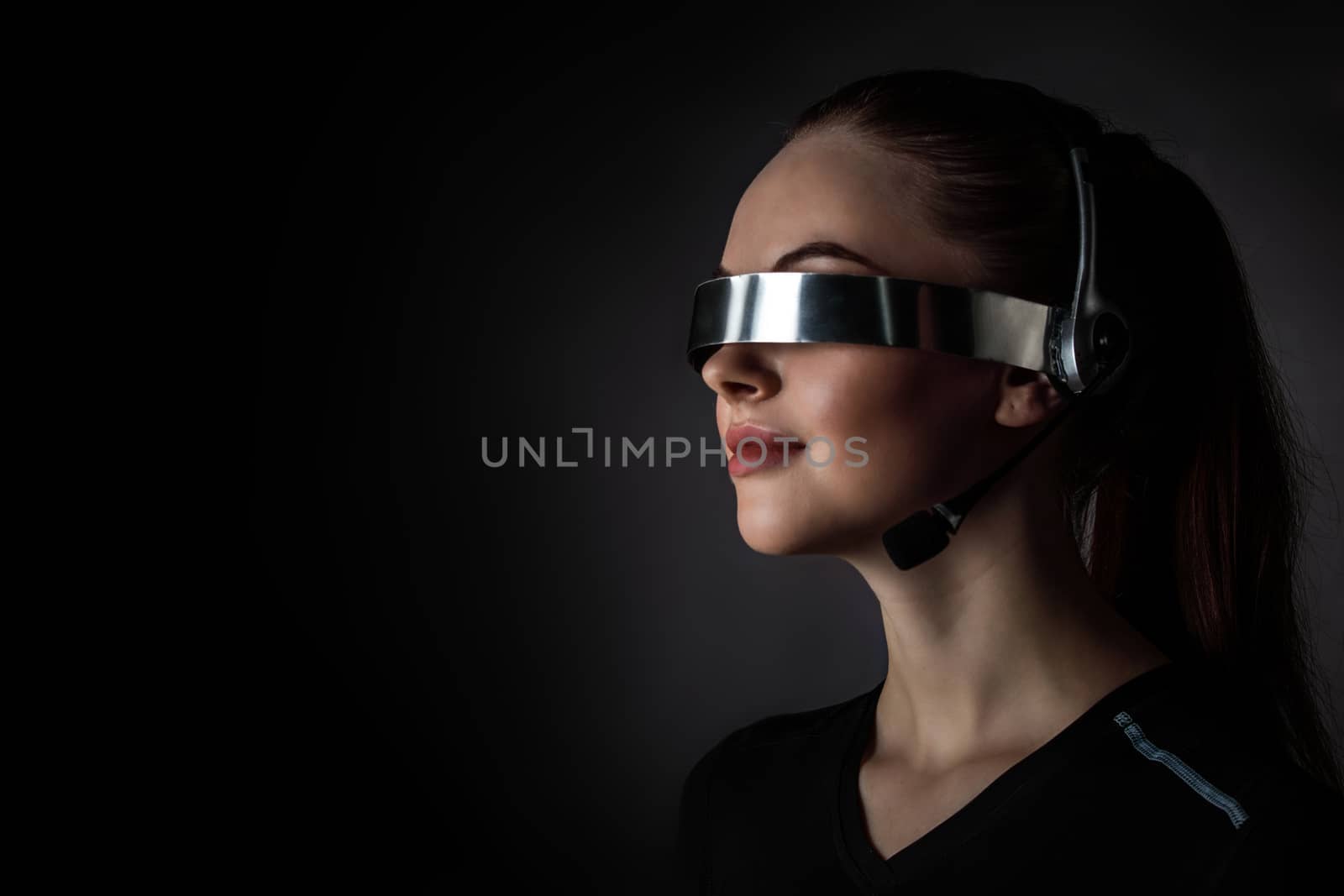 Woman using futuristic VR goggles by ALotOfPeople