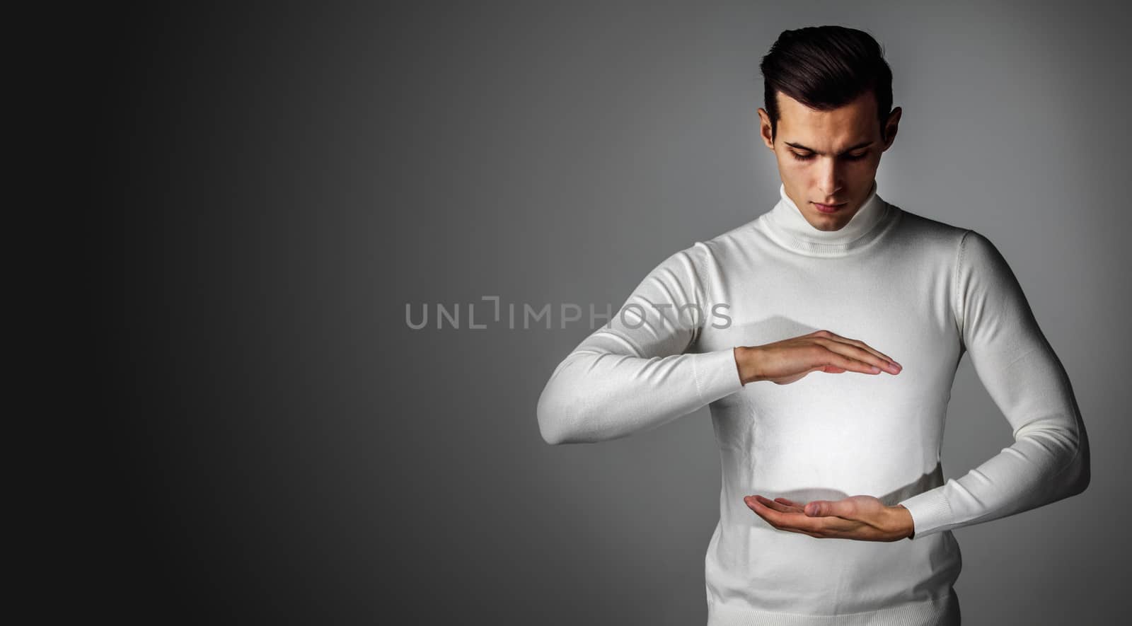 Innovation, future, futuristic object concept, man holding abstract glowing object, copy space for text design