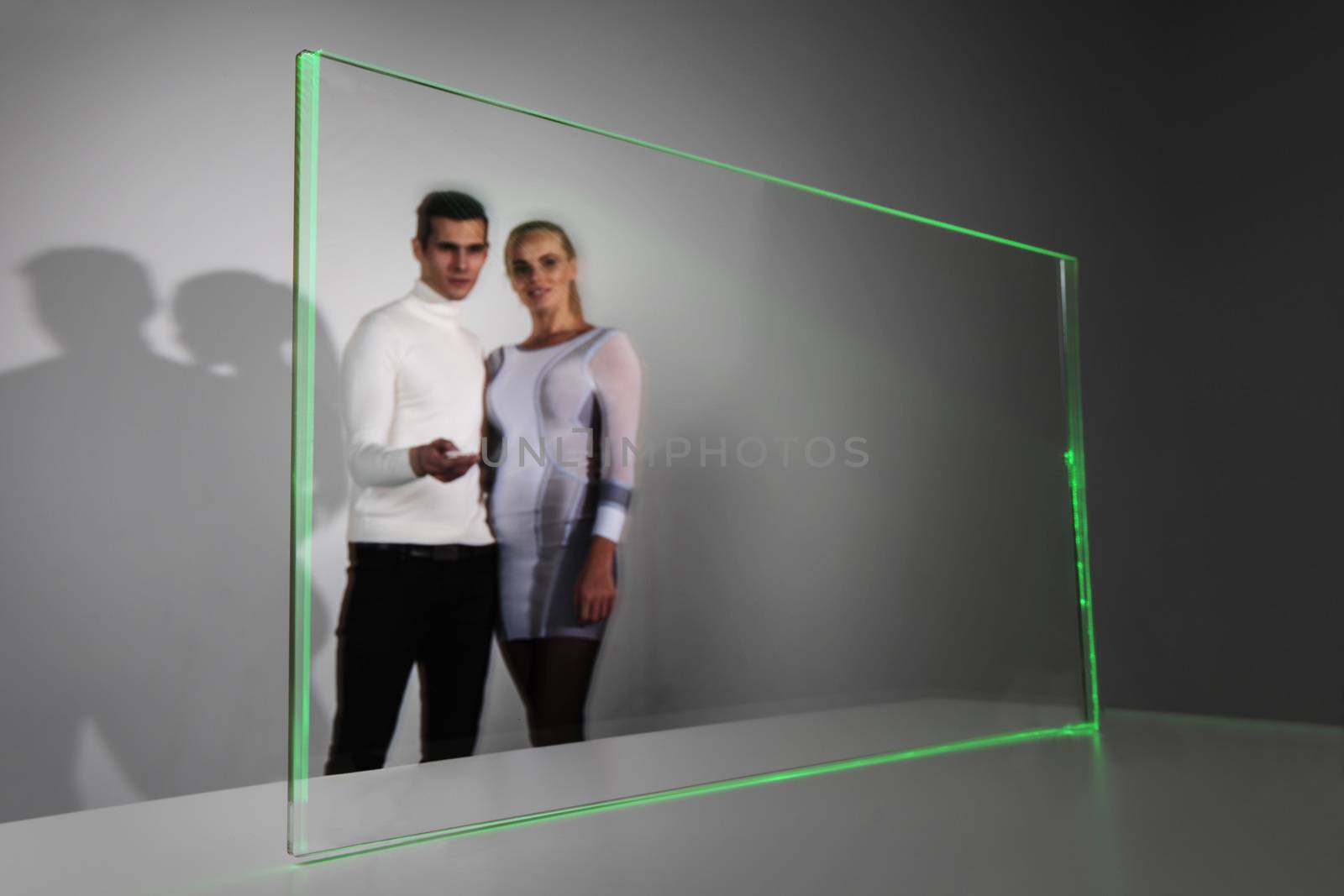 Couple working with futuristic display, innovation, future concept, copy space for text or design