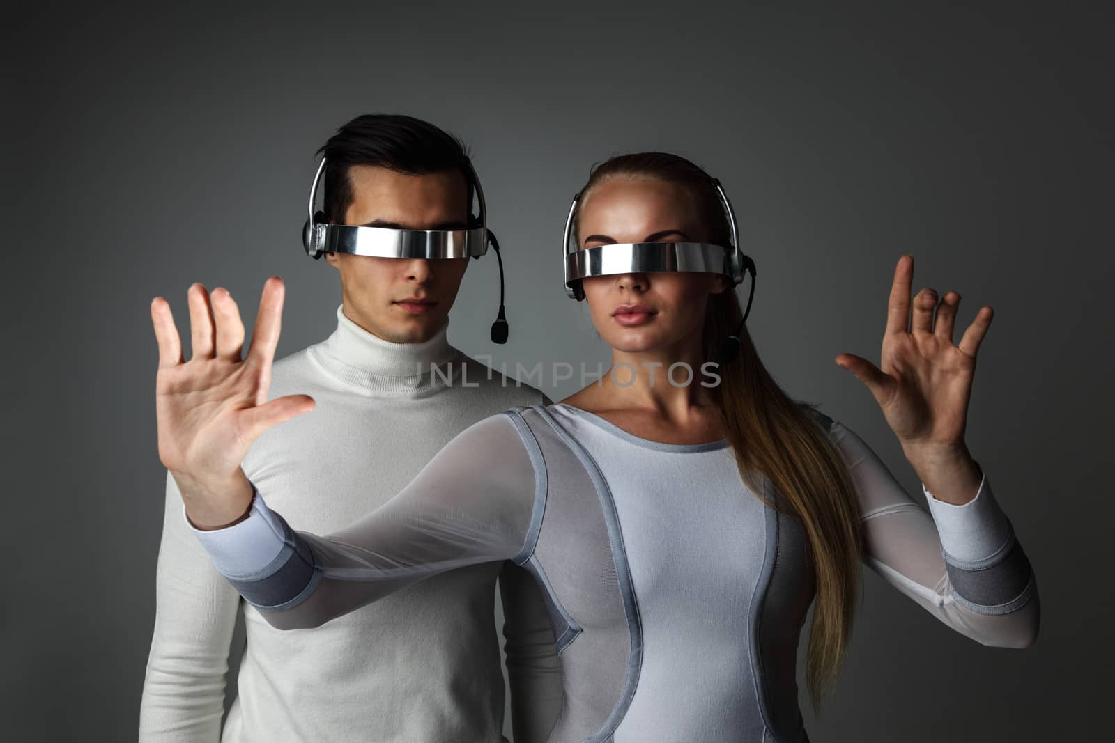 Couple working with futuristic display using futuristic VR goggles, innovation, future concept