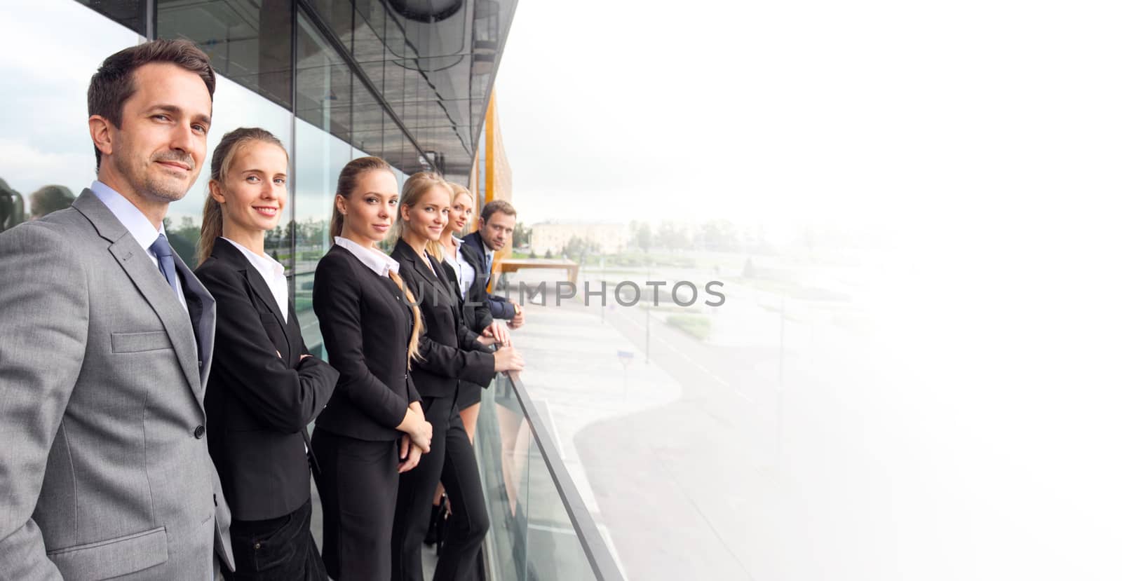 Business people team standing in a row at the balcony of modern office building