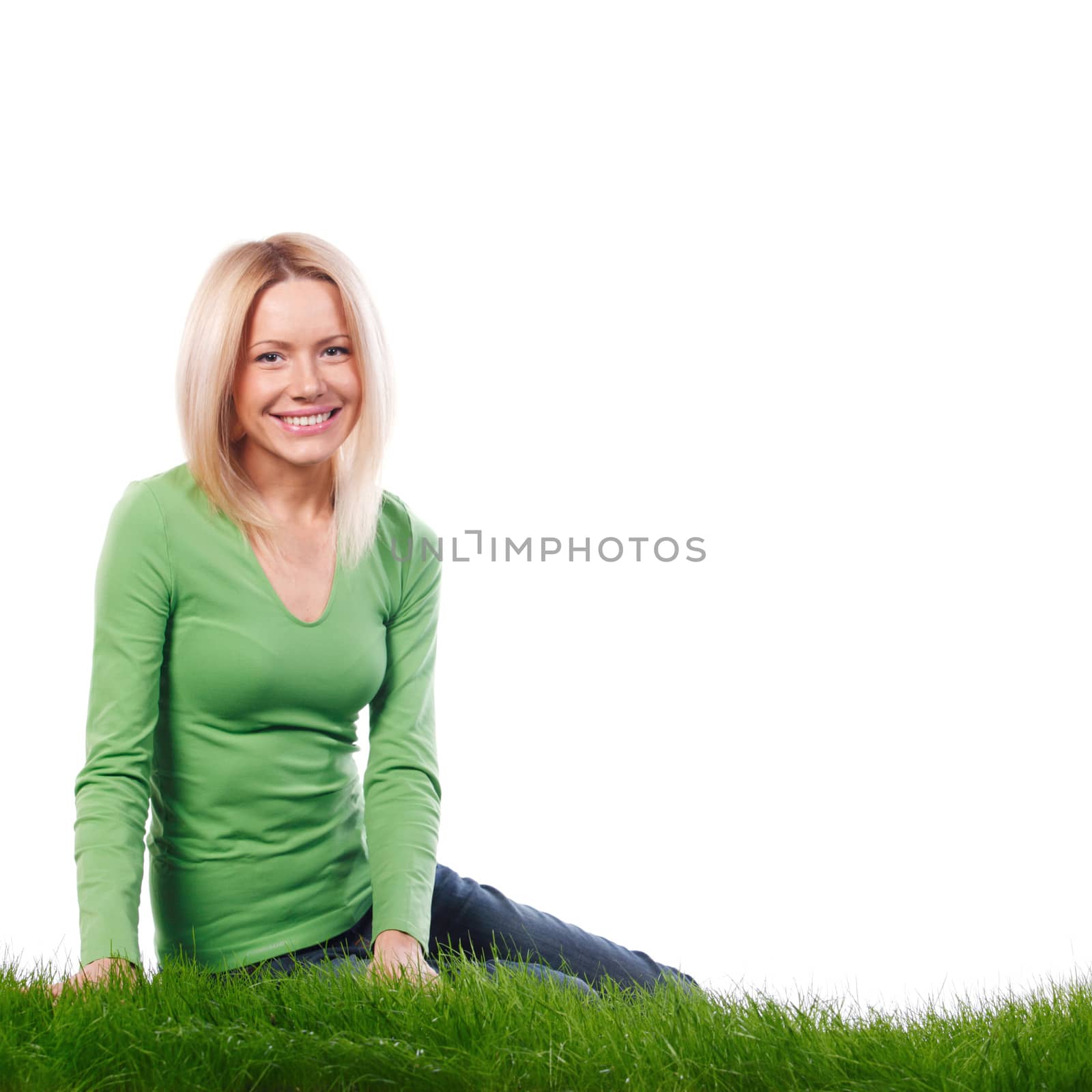 Young beautiful woman sitting on grass, isolated on white background