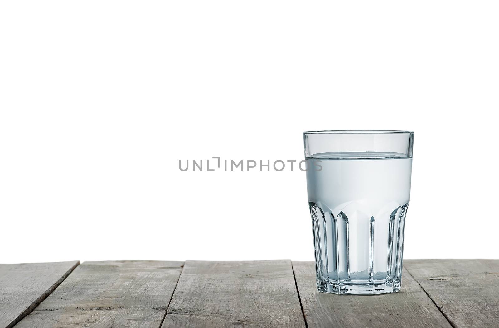 Glass of water on wooden table isolated on white background