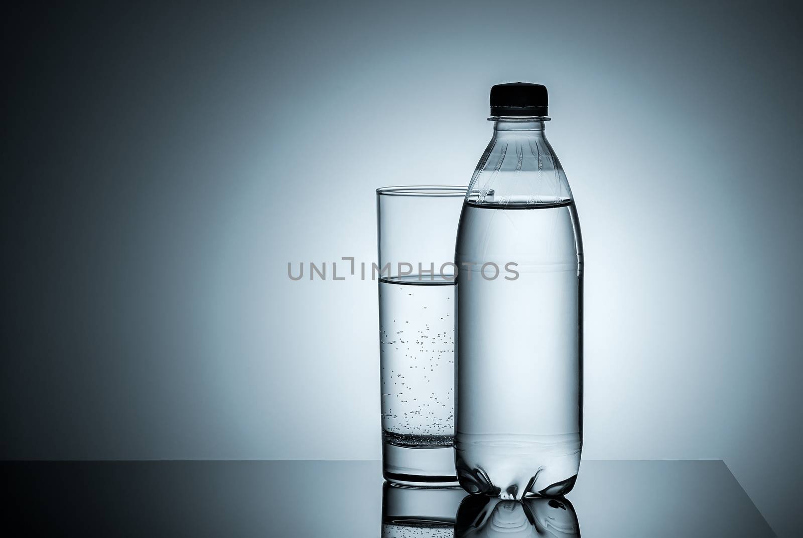 Plastic bottle and glass with water by Cipariss