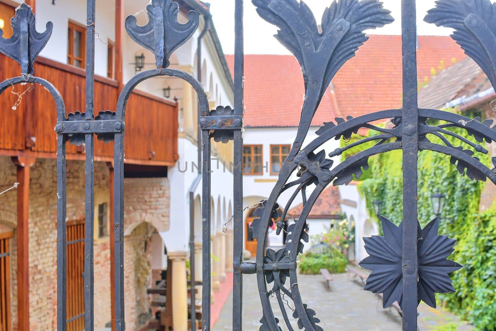View on romantic urban scenery through forged banister. Historic urban backyard by roman_nerud