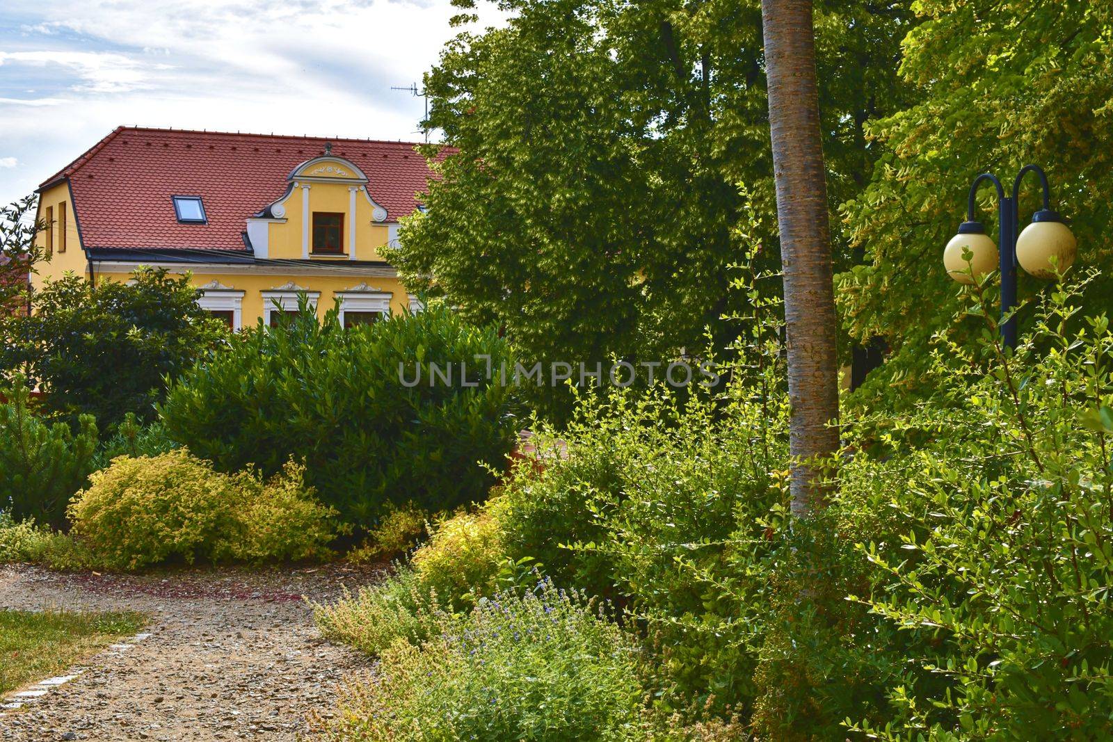 Urban historic background. Urban romantic park. Soft colors. Flowers and building on background. Selective focus by roman_nerud