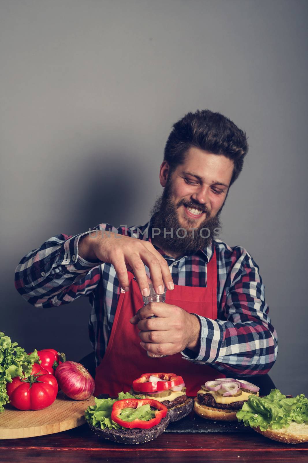 Man cooking fresh self made burgers close up