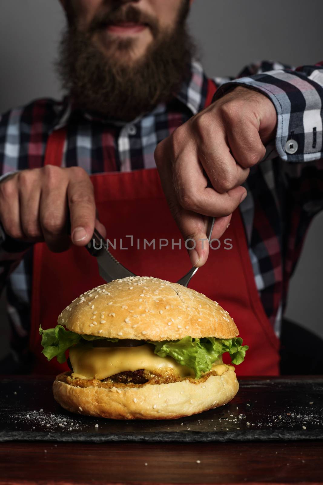 Man eating fresh self made burger close up