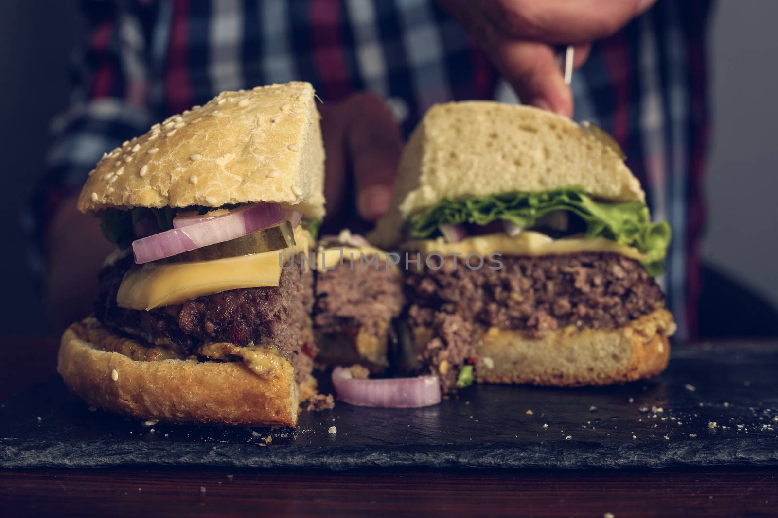 Man eating fresh self made burger close up