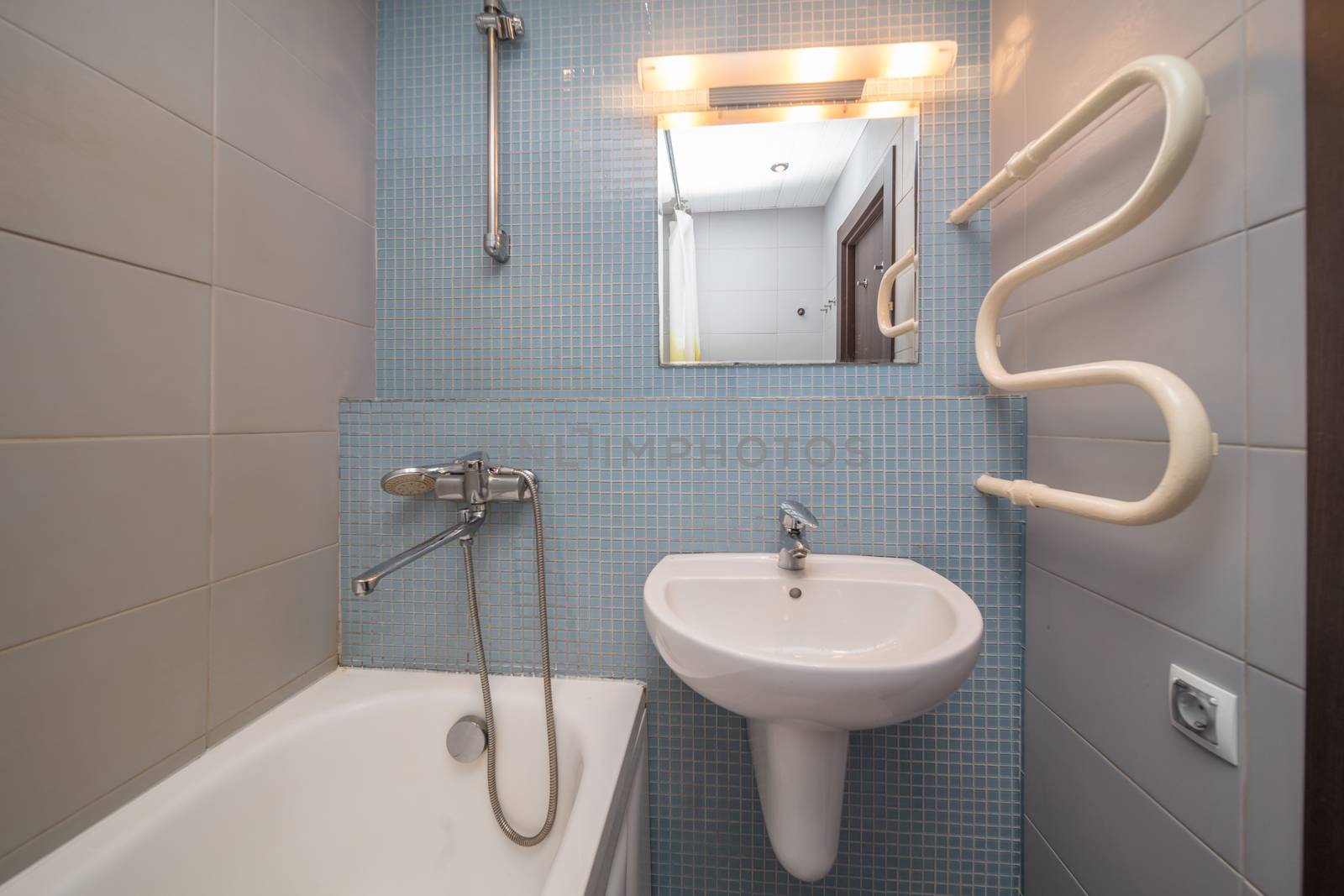 Small grey tile bathroom with bath tube and sink