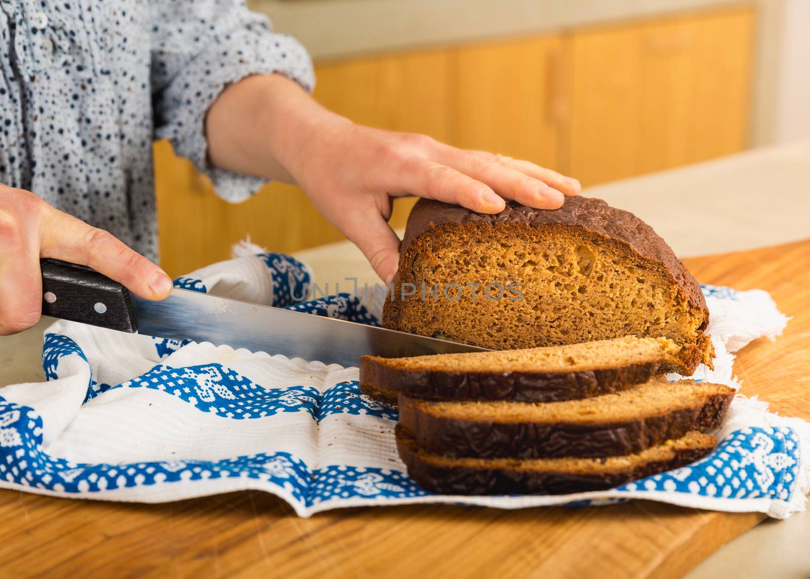 Woman cutting slices of gluten-free bread 