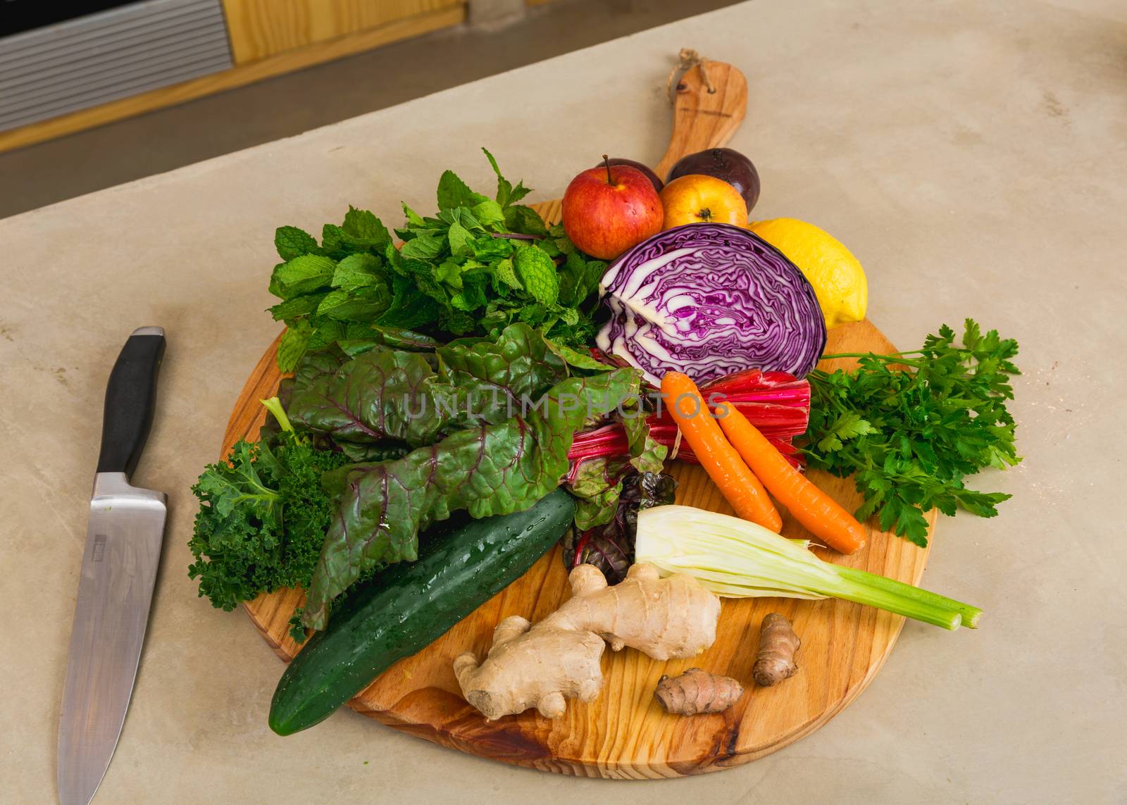 Several vegetables on top of a wooden board. Ingredients for detox diet. 