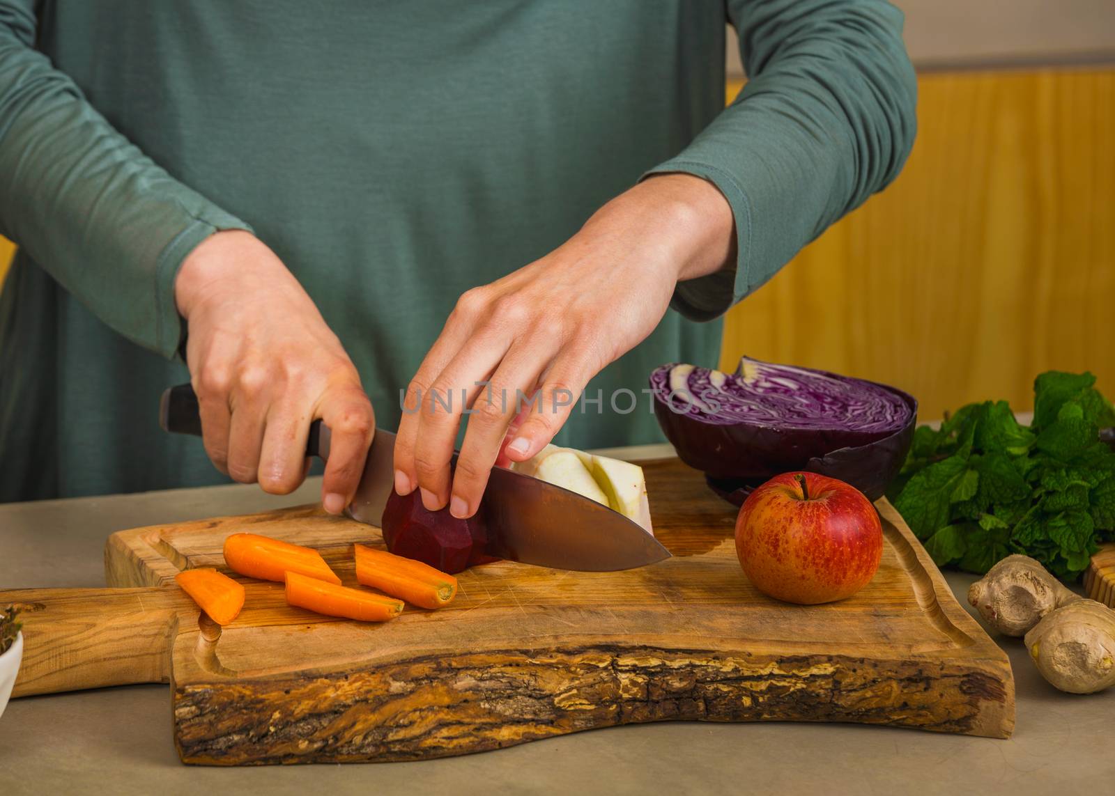 Several vegetables on top of a wooden board. Ingredients for detox juice.
