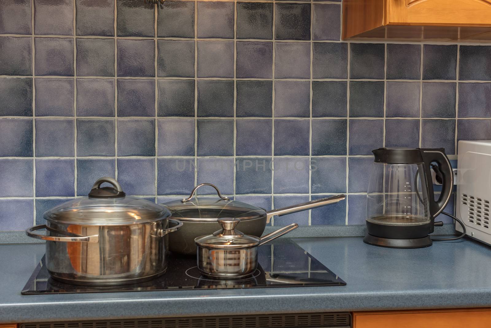 new stainless steel saucepan on modern kitchen range