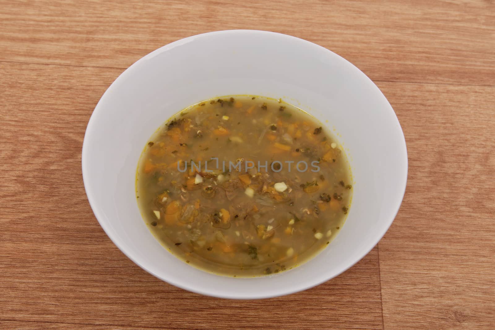 Lentil soup with carrot on a wooden table