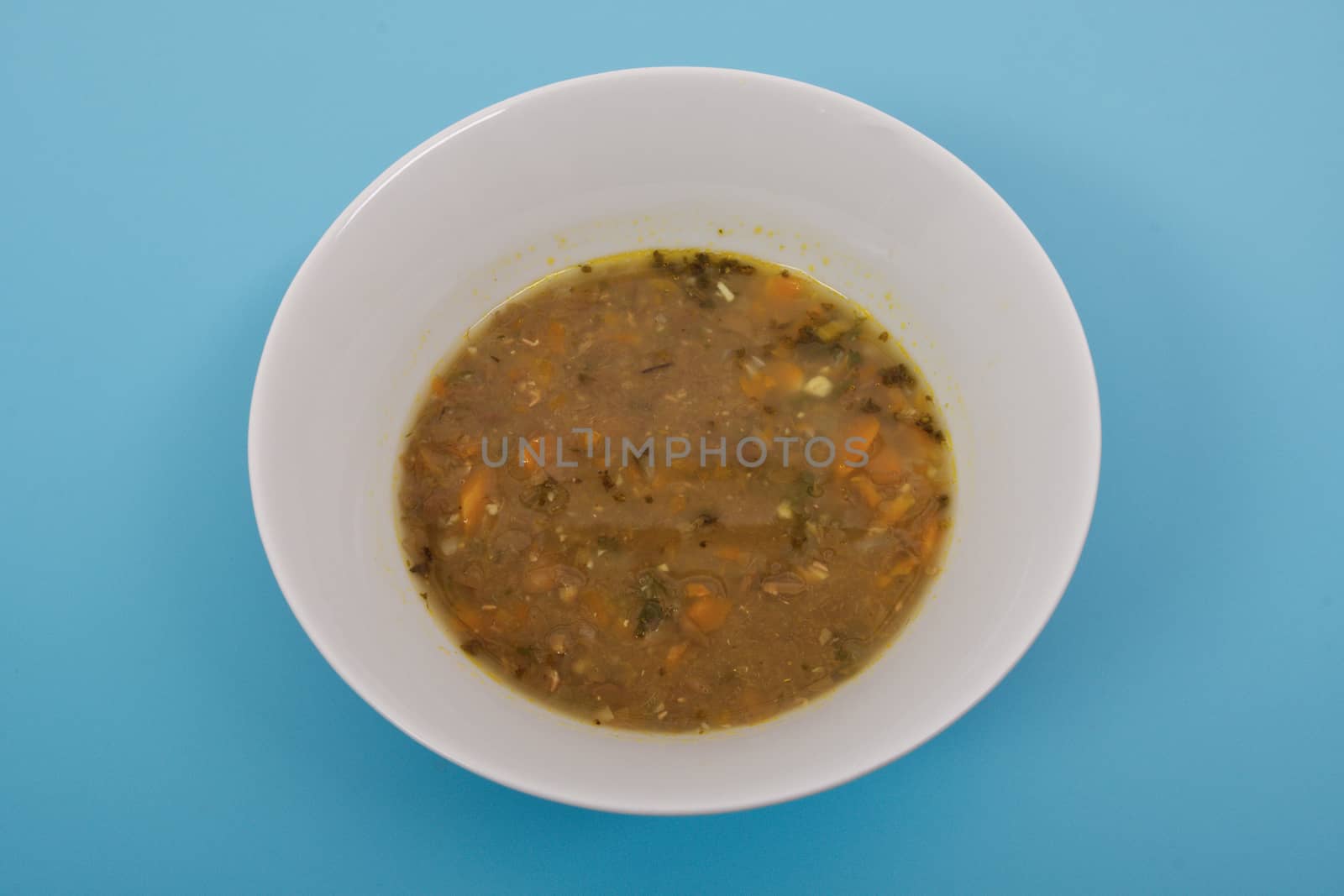 Lentil soup with carrot on a blue background