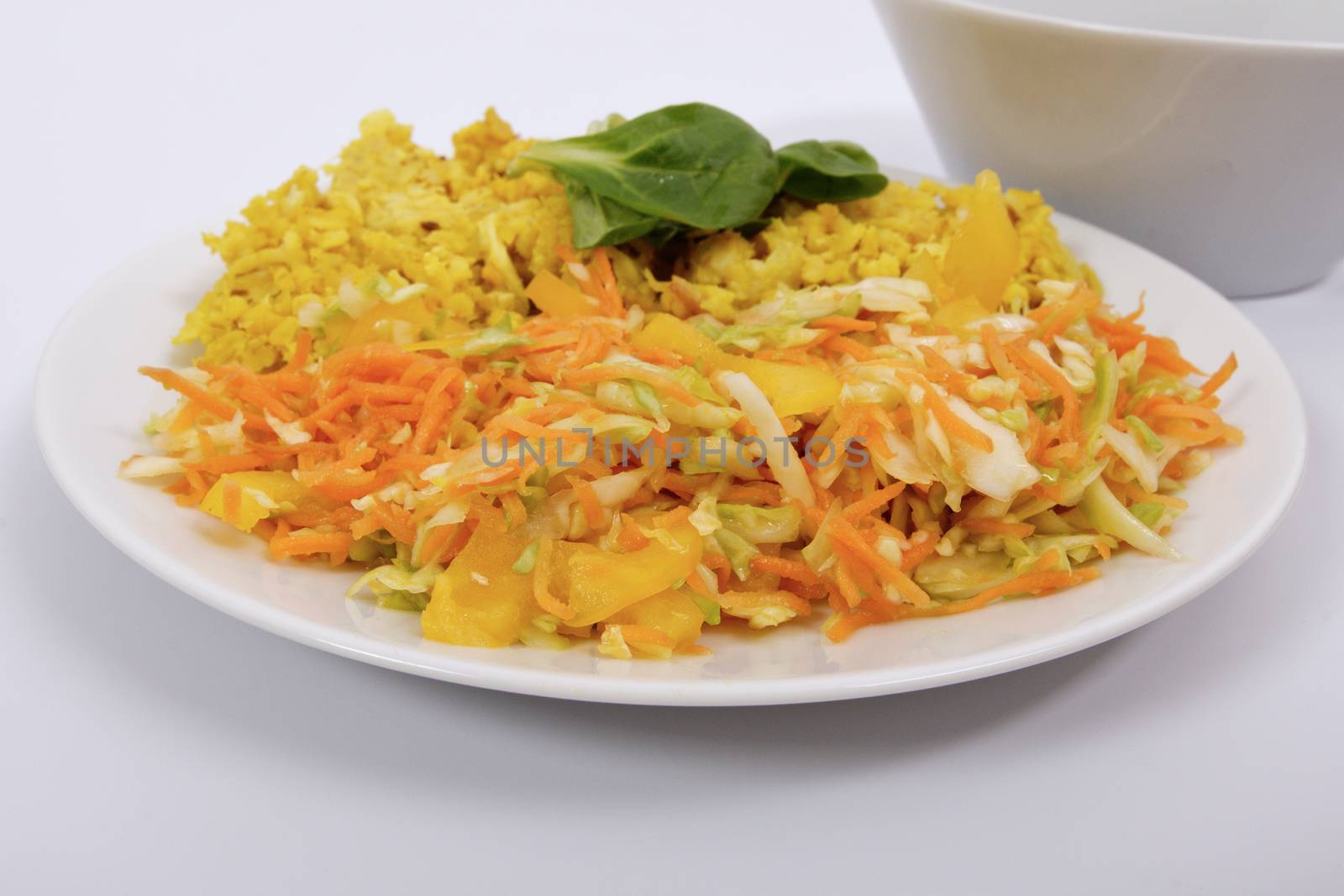 Baked Bulgar with cauliflower and vegetable salad on a white background