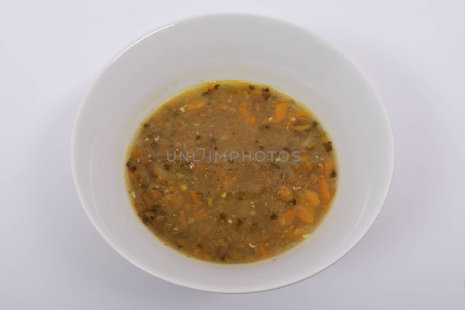 Lentil soup with carrot on a white background