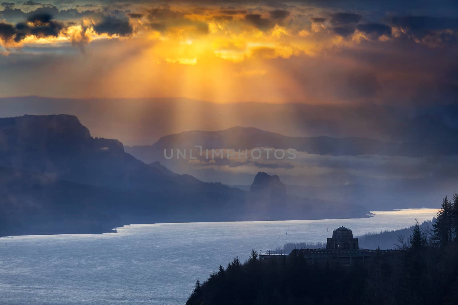 Sun rays over Crown Point and Beacon Rock along Columbia River Gorge during sunrise