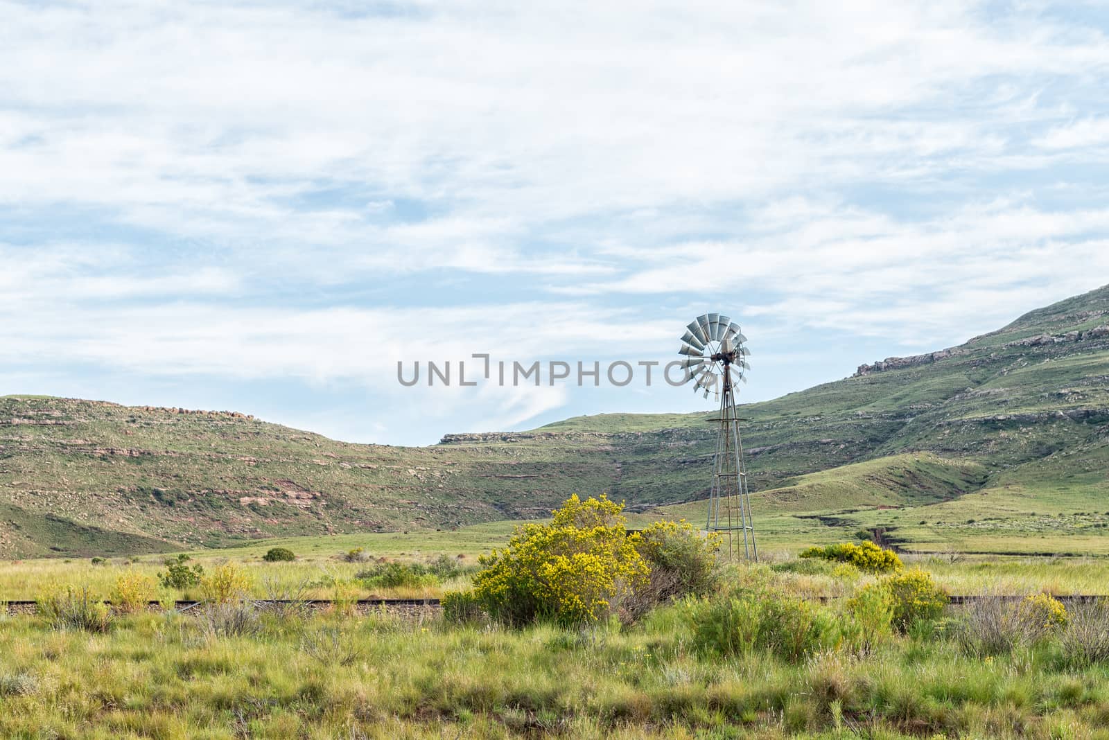 A landscape with a water-pumping windmill and the historic railway track between Lady Grey and Barkly East in the Eastern Cape Province