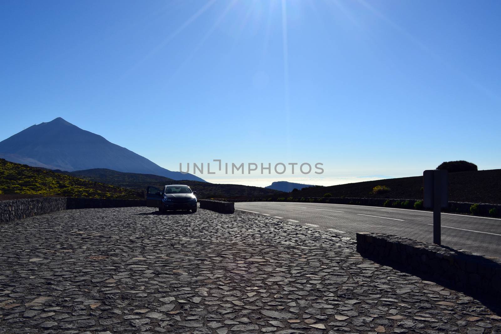 Road travel concept with car and Teide Peak in Tenerife, Canary Islands, Spain