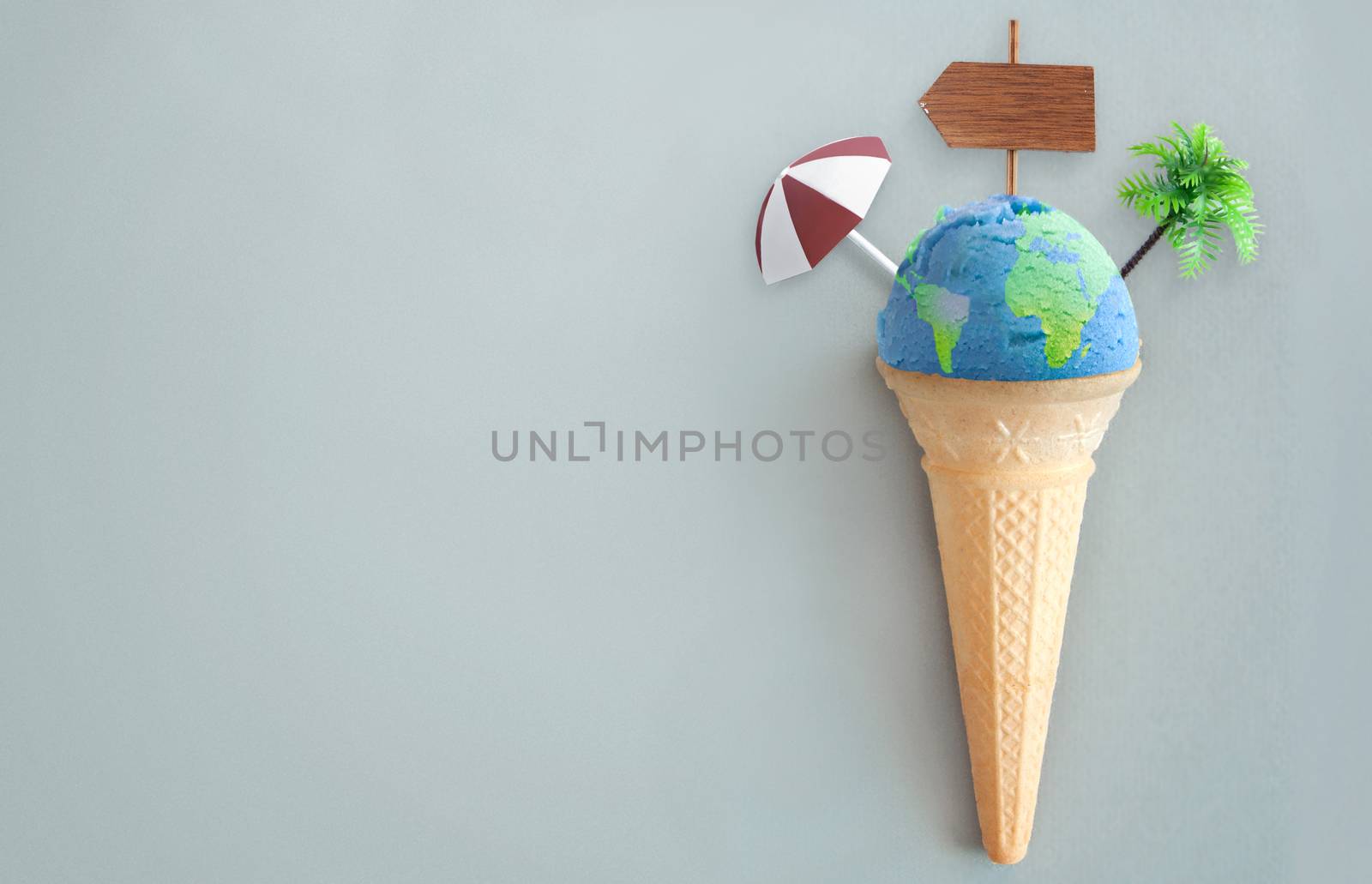 Ice cream scoop with world map and vacation items including beach post, parasol and palm tree