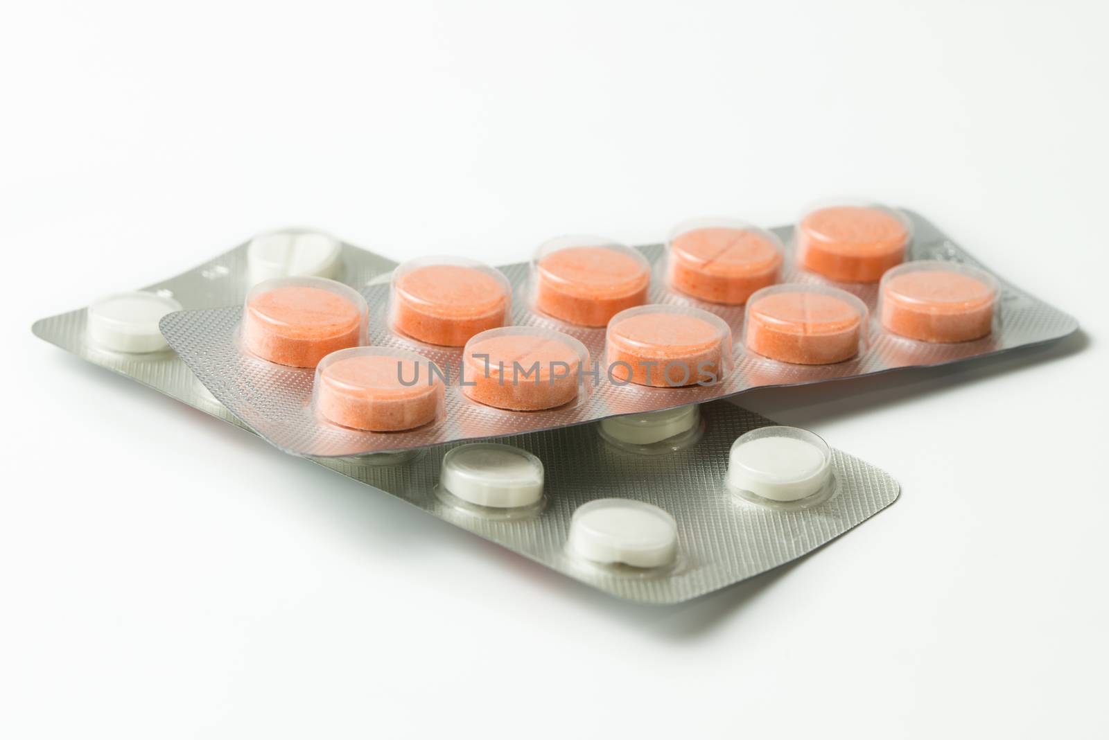 Set of pills in a plastic blister package by Kenishirotie