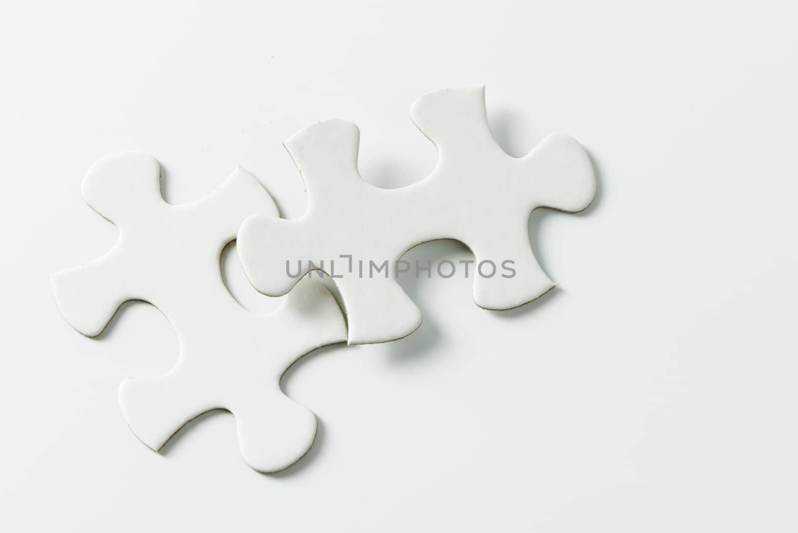 Two pieces of white jigsaw puzzle by Kenishirotie