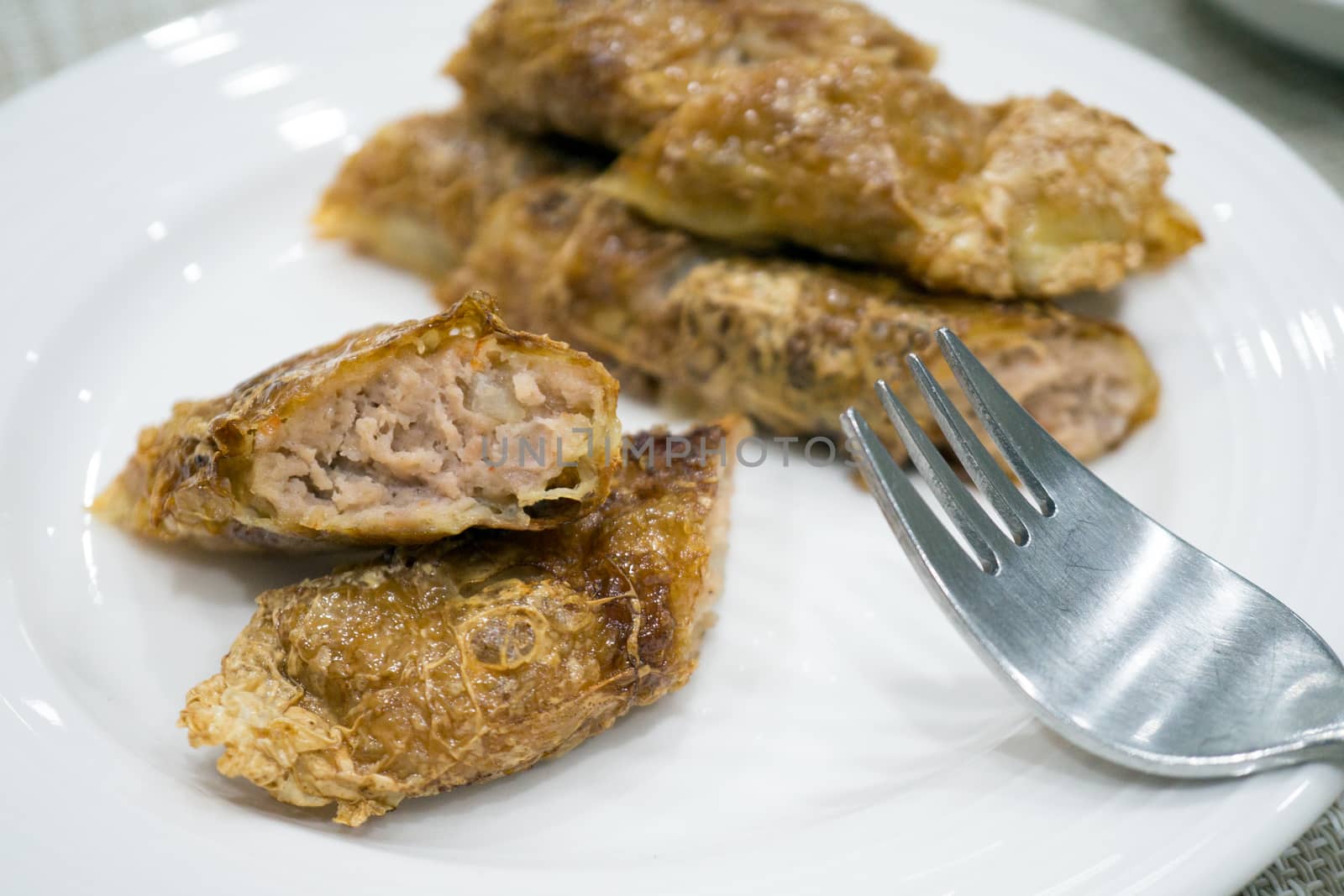 Penang Loh Bak is pork marinated in Chinese five spice powder, mixed with various ingredients, snugly rolled up with a sheet of bean curd and fried till crispy.