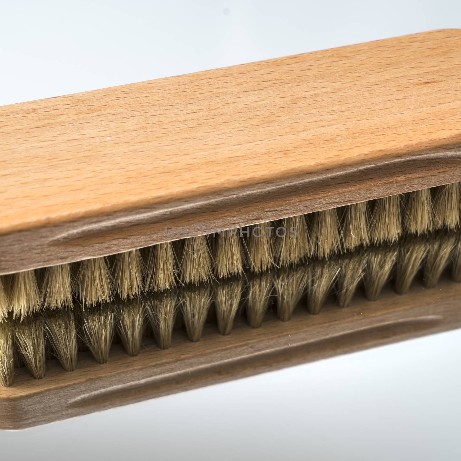 a clothes brush  on a mirror