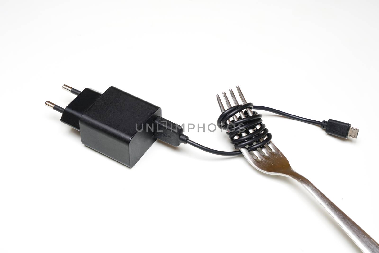 an electric cable wrapped around a fork                          