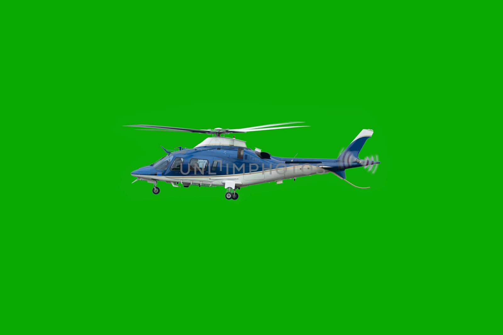 White and blue helicopter in flight, before landing with landing gear down, isolated on chroma green background