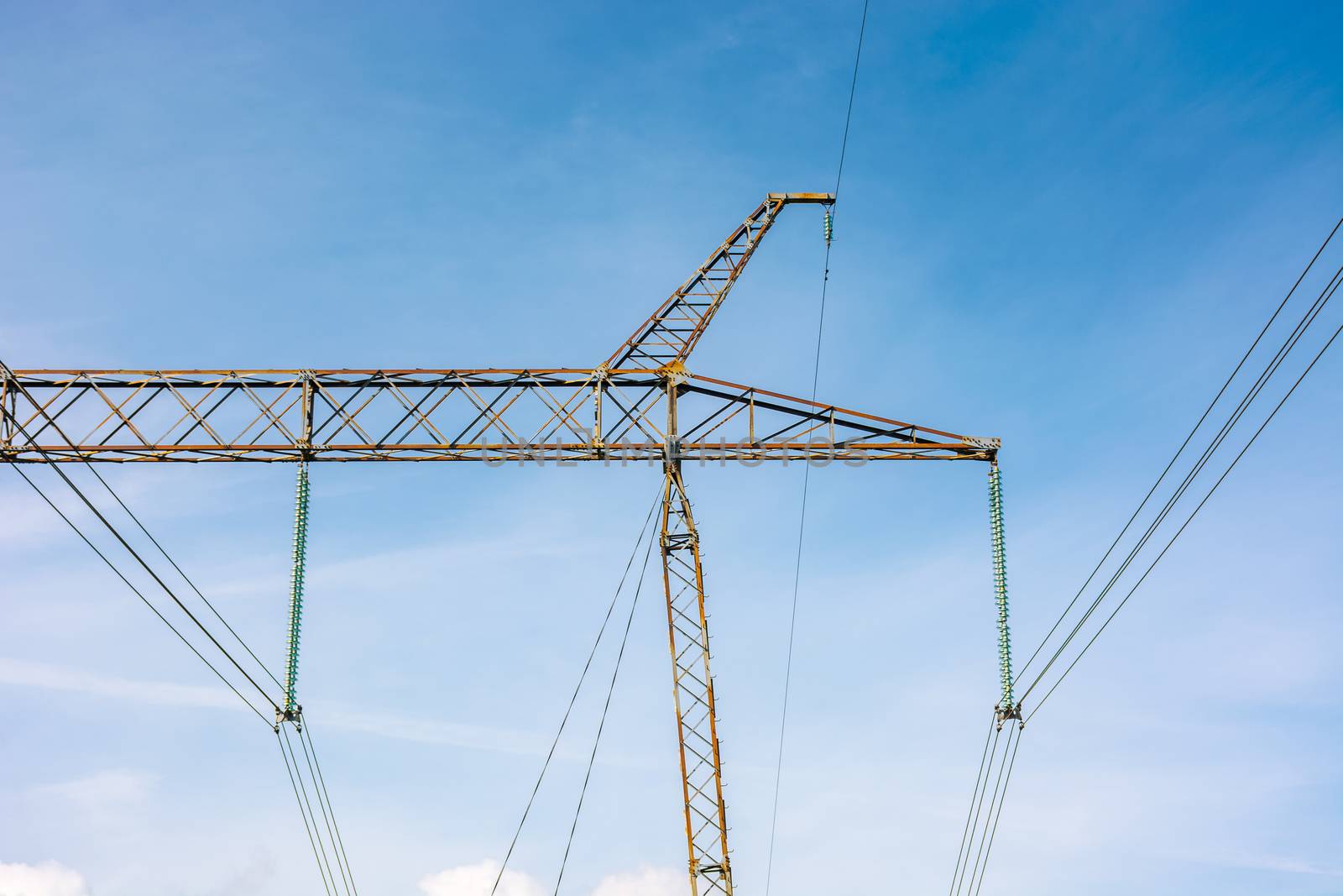 power lines tower against the blue sky. lovely energy industry background. efficient electricity delivery concept.