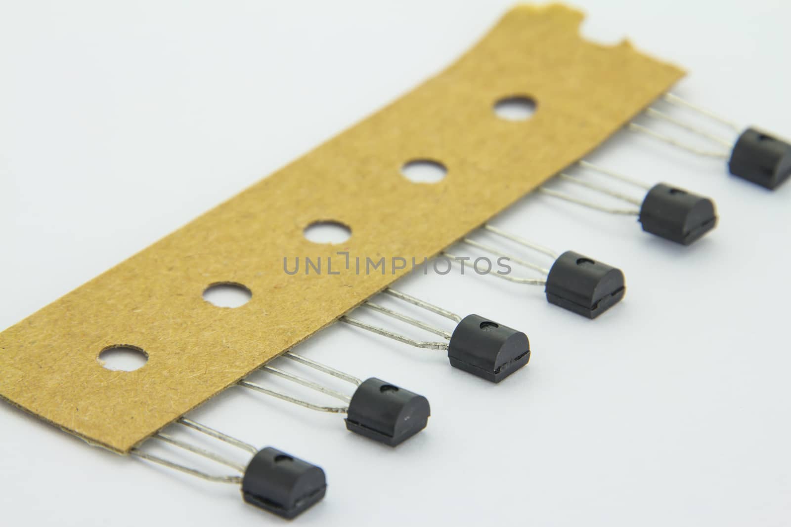 The old transistors with reel package on the white background by peerapixs