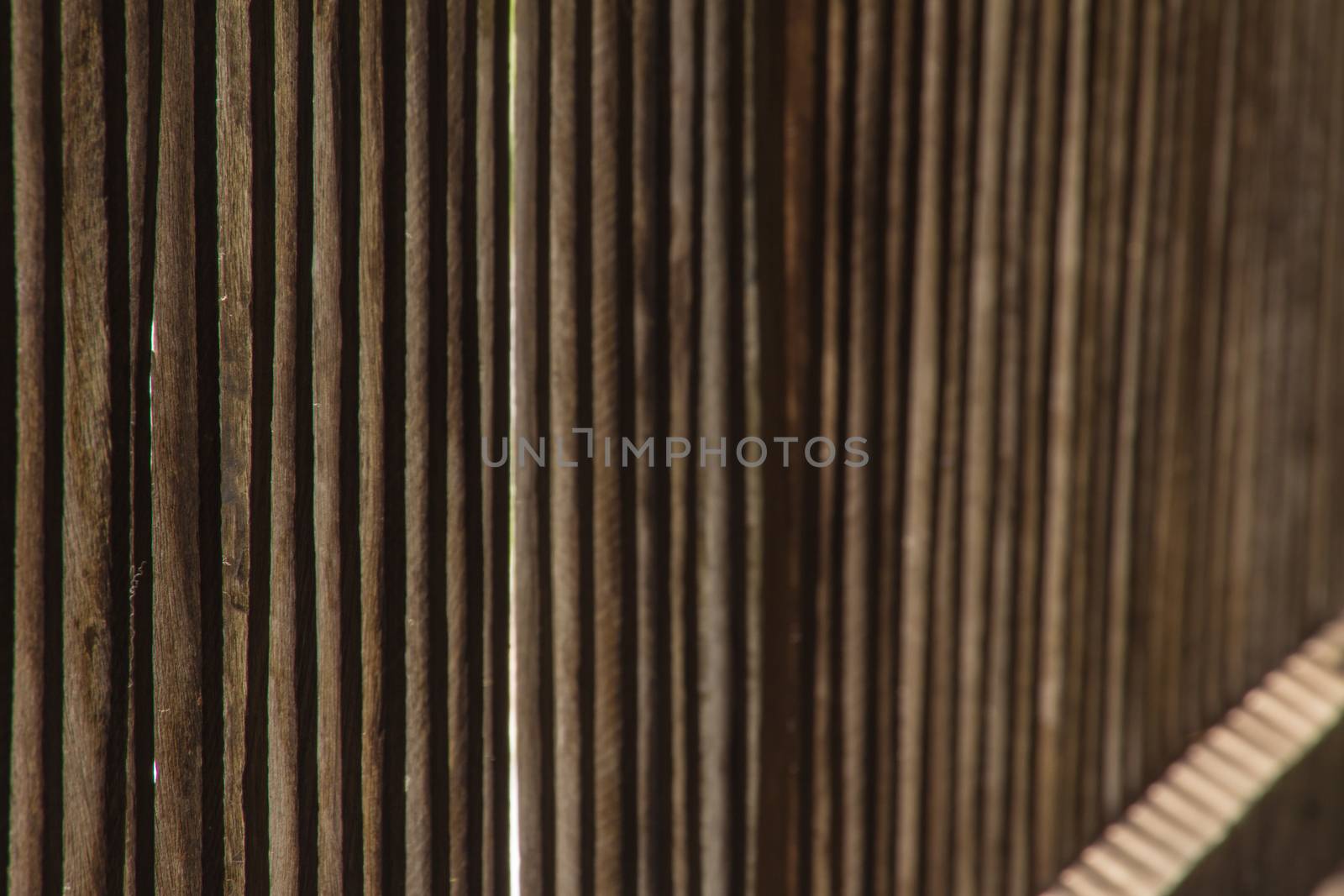 Old wooden vertical planks with horizontal slats left side focus