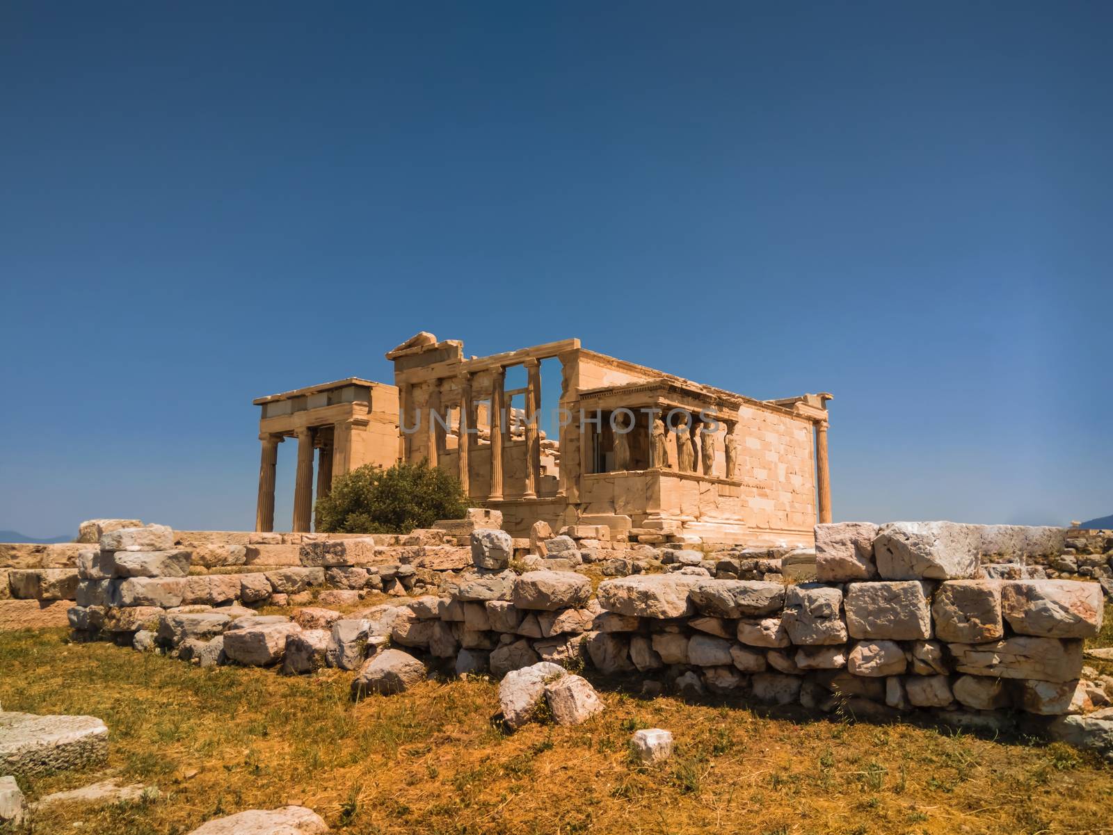 The building is on the north side of the Acropolis of Athens in Greece which was dedicated to both Athena and Poseidon