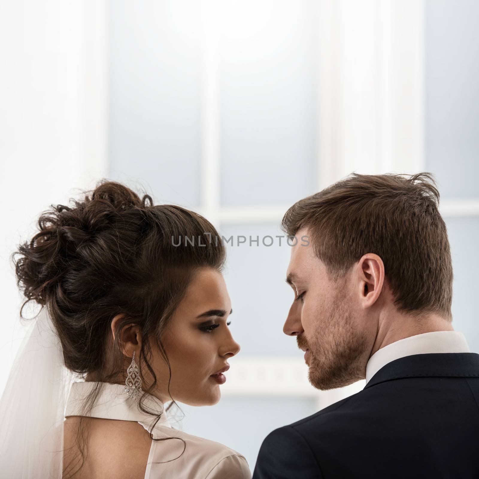 Groom and bride looking each to other by ALotOfPeople