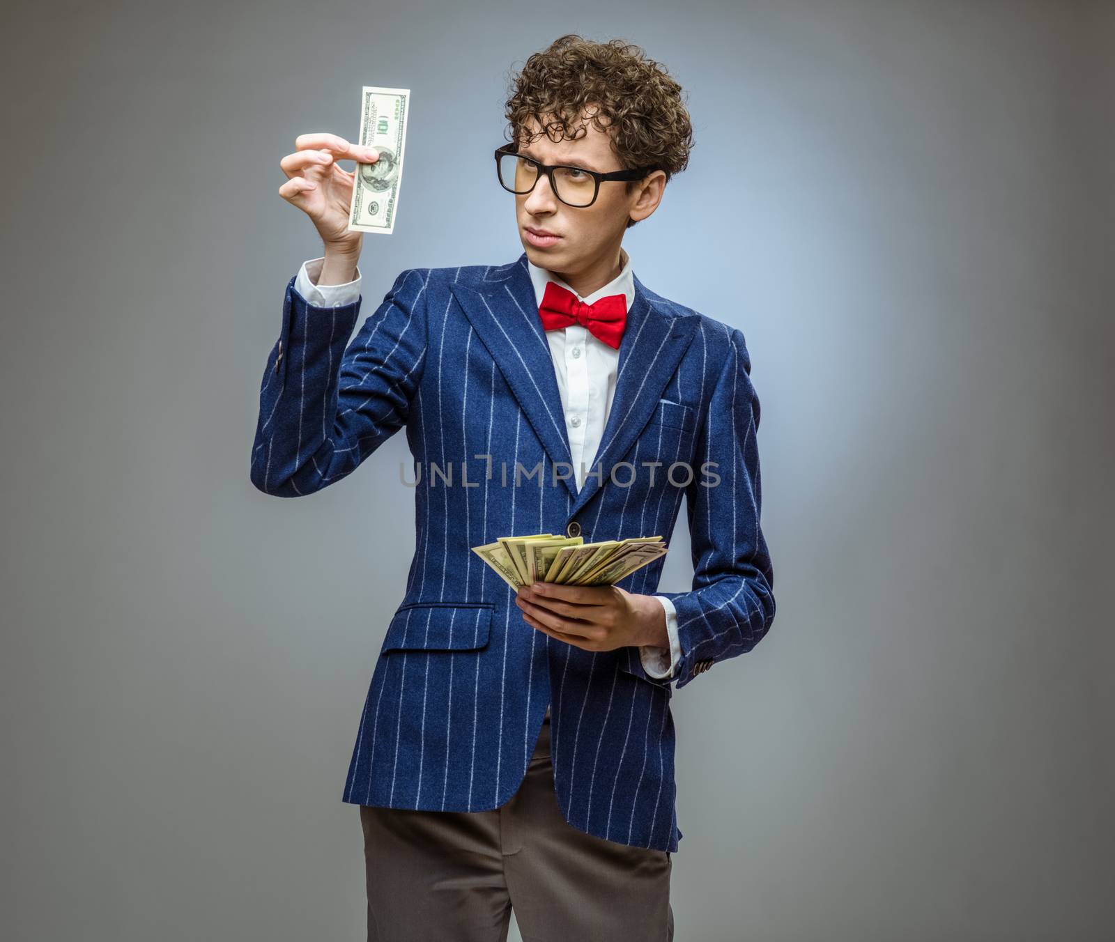 Man holding fan of dollar banknotes by ALotOfPeople